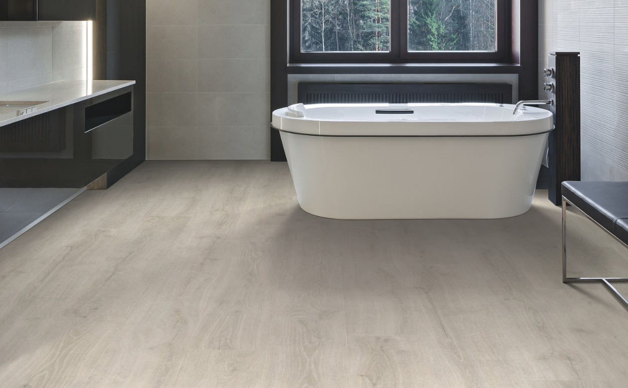Laminate flooring in a bathroom with a freestanding tub